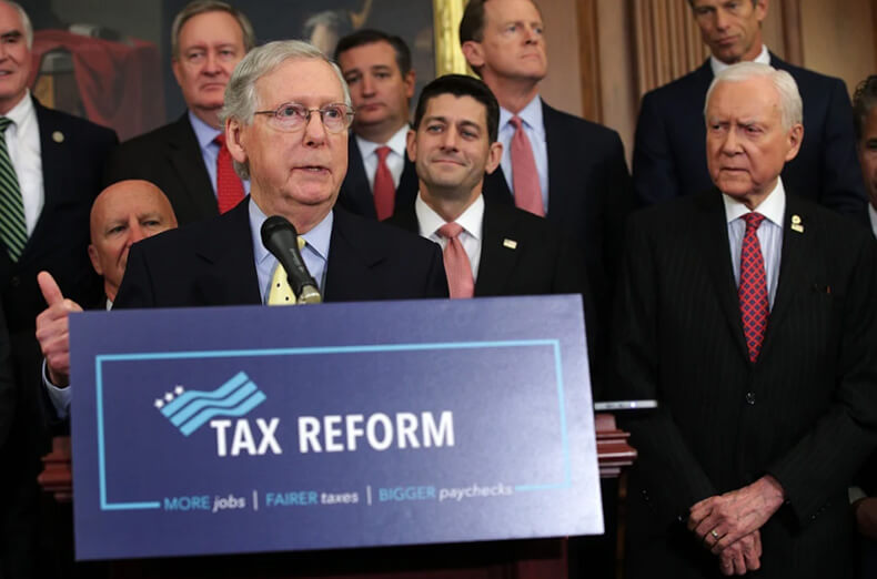 Group of U.S. lawmakers standing behind a podium during a press conference on tax reform.